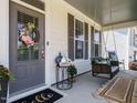 Cozy front porch featuring a swing and welcoming decor, perfect for relaxation at 2909 Thurman Dairy Loop, Wake Forest, NC 27587