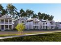 A row of houses feature sidewalks and tree-lined streets that add to the community's appeal at 332 White Oak Garden Way # 221, Garner, NC 27529