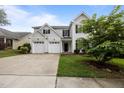 Charming two-story home featuring a two-car garage and meticulously maintained lawn with a beautiful shrub at 333 Trout Valley Rd, Wake Forest, NC 27587