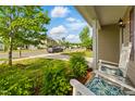 Relaxing front porch view with rocking chairs, manicured bushes, and a glimpse of a friendly neighborhood at 4108 Lady Slipper Ln, Durham, NC 27704