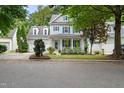 Two-story home with a two car garage, blue shutters, front porch, and manicured landscaping at 429 Marsh Landing Dr, Holly Springs, NC 27540