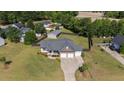 Spacious home with a three-car garage, well-maintained lawn, and a large, fenced backyard, perfect for outdoor activities at 45 Hawley Ridge Dr, Dunn, NC 28334