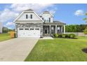 Charming two-story home with stone accents, two-car garage, and manicured lawn at 4504 Beckel Rd, Willow Springs, NC 27592