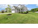 Charming two-story home with stone accents, two-car garage, and manicured lawn at 4504 Beckel Rd, Willow Springs, NC 27592
