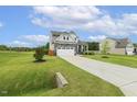 Charming two-story home with stone accents, two-car garage, and expansive yard at 4504 Beckel Rd, Willow Springs, NC 27592