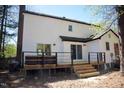 Rear exterior showcasing a wooden deck, providing a comfortable outdoor living space with sliding glass doors at 5013 Brassfield Dr, Rocky Mount, NC 27803