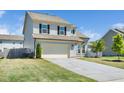 View of two-story home and a two car garage with a concrete driveway at 51 Duchess Ave, Franklinton, NC 27525