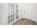 Bright foyer features hardwood floors, white walls, glass paneled doors, and a white front door at 51 Duchess Ave, Franklinton, NC 27525
