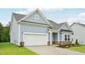 Beautiful home featuring light blue siding, a brick foundation, and an attached two-car garage at 529 Winding Creek Drive Dr, Lillington, NC 27546
