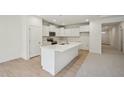 Bright, all-white kitchen featuring an island, stainless appliances, and lots of cabinet space at 529 Winding Creek Drive Dr, Lillington, NC 27546