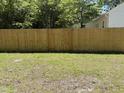 Expansive backyard featuring a well-maintained lawn and a new wooden fence providing security and privacy at 541 N Daughtry St, Rocky Mount, NC 27801
