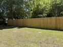 Spacious backyard showcasing a newly constructed wooden fence, providing privacy and enhancing the outdoor space at 541 N Daughtry St, Rocky Mount, NC 27801