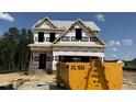 Unfinished new construction home showing its frame with Home Guard protection on a sunny day at 58 Butterbean Ct, Zebulon, NC 27597