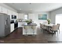 Spacious kitchen with an island, stainless appliances, and a dining area with a marble table at 58 Butterbean Ct, Zebulon, NC 27597