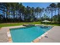 Beautiful backyard pool with hot tub and sunbathing area at 6 Castlewood Dr, Durham, NC 27713