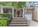 Inviting brick staircase leading to a covered front porch with columns and decorative plants at 625 Canvas Dr, Wake Forest, NC 27587