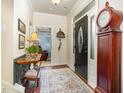 Inviting entryway features hardwood floors, a grandfather clock, decorative rug, and ample natural light at 8005 Crookneck Dr, Angier, NC 27501