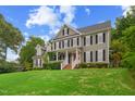 View of a two-story home with a manicured lawn, and a welcoming front porch at 809 Parkridge Dr, Clayton, NC 27527