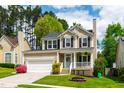 Charming two-story home with a well-manicured lawn and inviting front porch at 8613 Swarthmore Dr, Raleigh, NC 27615