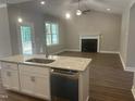 Open-concept kitchen showcasing granite counters, stainless appliances, and a seamless transition to the cozy living area at 9254 Turkey Way, Middlesex, NC 27557