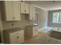 Kitchen with white cabinets, stone countertops, and stainless steel fixtures at 9254 Turkey Way, Middlesex, NC 27557