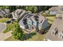 Aerial view of a two-story home with blue siding, solar panels, and fenced backyard at 94 Pearsall Farm Ln, Clayton, NC 27527