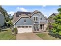 Charming home boasts solar panels, two-car garage, blue siding, and inviting front patio at 94 Pearsall Farm Ln, Clayton, NC 27527