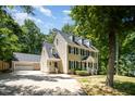 Lovely two-story home with attached two car garage and a sprawling driveway surrounded by mature trees at 103 Donna Pl, Cary, NC 27513