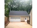 Spacious two-car garage with a white door and side entry, providing ample parking and storage at 103 Donna Pl, Cary, NC 27513