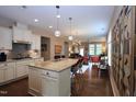 Open-concept kitchen with granite counters, stainless steel appliances, and hardwood floors at 1033 Cuthbert Ln, Durham, NC 27703