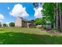 Expansive backyard features a well-maintained lawn, mature trees, and a large, covered deck at 108 Christy Circle Ln, Clayton, NC 27520