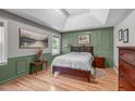 Stylish bedroom with tray ceilings, warm wood flooring, and ample natural light at 108 Christy Circle Ln, Clayton, NC 27520