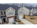 Overhead view of the property showcasing the townhome's layout, driveway, and surrounding neighborhood at 1109 Banworth Ct, Mebane, NC 27302