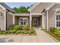 The front porch of the home has lovely landscaping, includes rocking chairs and a decorative flower pot at 1129 Santa Cruz St, Wake Forest, NC 27587