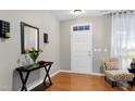 Elegant entryway with hardwood floors, decorative mirror, and stylish accents, offering a warm welcome to guests at 1141 Brookhill Way, Cary, NC 27519