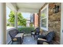 Relaxing outdoor porch with comfortable wicker seating and stylish stone flooring, perfect for enjoying fresh air at 1141 Brookhill Way, Cary, NC 27519