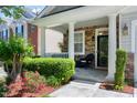 Inviting front porch with stone accents, lush landscaping, and cozy seating, creating a welcoming entrance at 1141 Brookhill Way, Cary, NC 27519