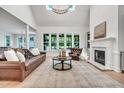 A living room with hardwood floors, large windows and a fireplace at 1225 Fanning Dr, Wake Forest, NC 27587