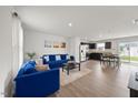 Bright, open-concept living area with hardwood floors, modern furniture, and natural light at 1303 Bent Willow Dr, Durham, NC 27704
