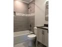Updated bathroom with a tiled shower, modern fixtures, and vanity at 157 Thorpe St, Henderson, NC 27536