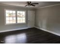 Well-lit living room with sleek wood floors and a neutral color palette at 157 Thorpe St, Henderson, NC 27536