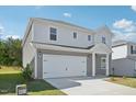 A modern two story home with light gray siding, a well manicured front yard and an attached two car garage at 1730 Pie Filling Dr, Haw River, NC 27258