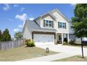 View of the home's exterior showcasing the yard, 2 car garage and well-maintained landscaping at 1940 Dunfield Dr, Fuquay Varina, NC 27526