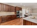Spacious kitchen featuring stainless steel appliances, ample storage, beautiful counter tops, and hardwood floors at 196 Norwich Dr, Clayton, NC 27520