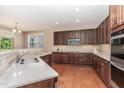 Modern kitchen with wood cabinets, stainless steel appliances, quartz countertops, and hardwood floors at 196 Norwich Dr, Clayton, NC 27520