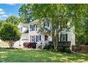 Beautiful two-story home with manicured lawn, complemented by lush trees at 215 Rocky Point Ct, Fuquay Varina, NC 27526