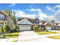Charming two-story home with stone accents, red shutters, landscaped yard, and a two-car garage at 2217 Holtwood Way, Apex, NC 27523