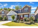 Charming two-story home with stone accents, red shutters, landscaped yard, and a two-car garage at 2217 Holtwood Way, Apex, NC 27523