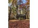 Beautiful home surrounded by trees during fall with the leaves changing colors at 2603 Red Pine Rd, Hillsborough, NC 27278