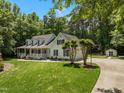 Beautiful home with an attached two-car garage, mature landscaping, and a well-maintained lawn at 2616 Dockery Ln, Raleigh, NC 27606